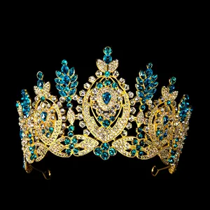 Detailed close-up of Baroque crown with blue teardrop gems and intricate gold metalwork