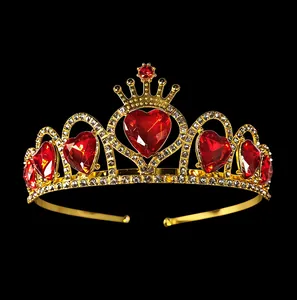 Detail of gold princess crown featuring red heart crystals and sparkling white rhinestones