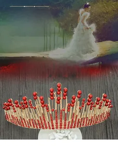 Detailed view of luxury red crystal bridal crown with golden alloy and elegant beads