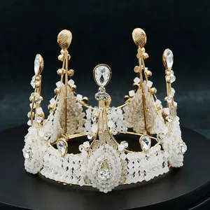 Detailed close-up of golden crown with white pearls and sparkling rhinestones