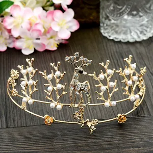 Close-up of golden deer crown featuring sparkling rhinestones and white pearls for parties