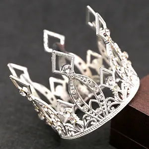 Detail of silver hollow mini crown with sparkling rhinestones and vintage patterns