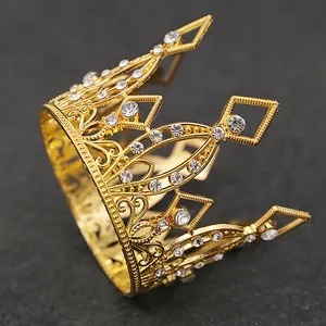 Detailed close-up of golden crown with intricate scrollwork and sparkling white rhinestones