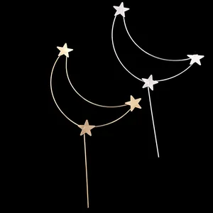Detailed close-up of gold and silver moon and star shaped cake toppers or hair accessories