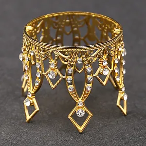 Detailed close-up of golden hollow crown display stand with sparkling rhinestones
