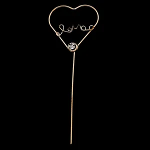 Elegant gold metal heart cake topper with Love lettering and crystal rhinestone accent