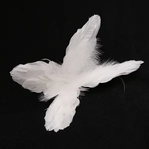 Luminous white feather angel wings cake topper decoration on black textured background