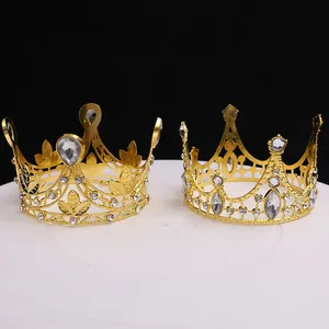 Macro detail of two ornate golden cake topper crowns with sparkling crystal rhinestones