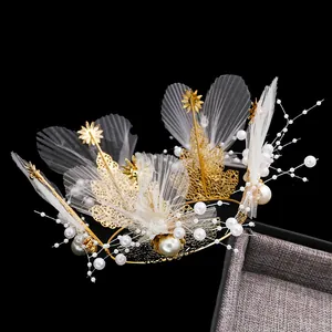 Elegant gold metal crown cake topper with white pearls and mesh decoration for birthday dessert