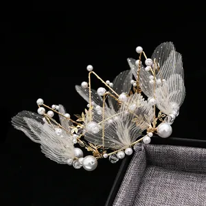 Elegant gold metal crown with white pearls and lace wings for cake decoration