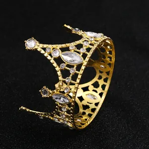Golden crown cake topper with white sparkling crystals on elegant black background