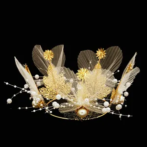 Detail of golden floral crown with white pearls and delicate tulle mesh for cake decor