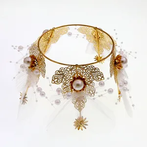 Elegant gold flower crown cake topper with white pearls and delicate mesh wings