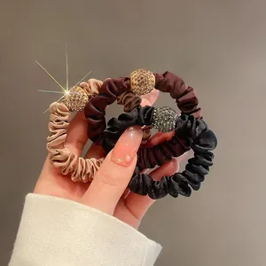 Three-pack elastic silk hair ties with rhinestone-encrusted golden beads for women