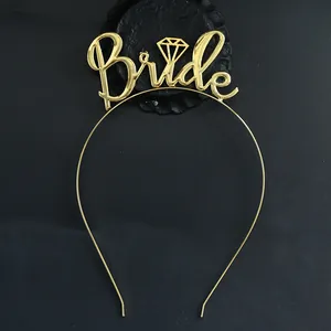 Macro view of gold Bride headband featuring diamond accent on the letter i