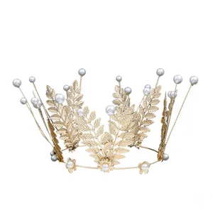 Elegant gold leaf crown with white pearls for bridal hair and cake decoration
