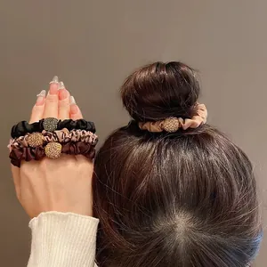 Elastic satin hair ties with rhinestone charms in black, leopard, and brown colors