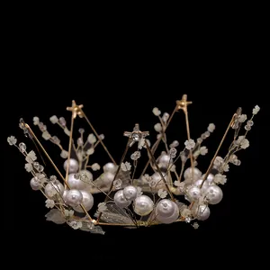 Detail of gold crown with lace flowers, white pearls and star-shaped metal accents