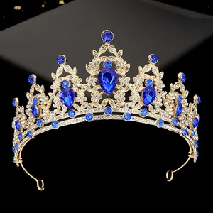 Detailed macro view of gold alloy tiara with blue teardrop stones and sparkling crystals