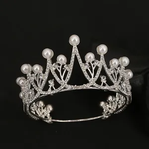 Macro detail of silver bridal crown with sparkling rhinestones and elegant pearls