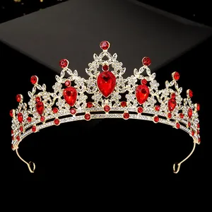 Close-up of golden bridal crown with red teardrop gemstones and sparkling rhinestones