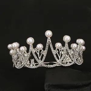 Elegant bridal tiara with silver rhinestones and pearls on a sleek black stone base