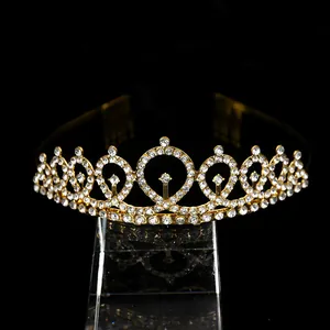 Detailed close-up of golden birthday crown with clear rhinestones and built-in hair combs
