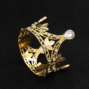 Macro shot of golden metal crown with sparkling leaf pattern and clear rhinestones