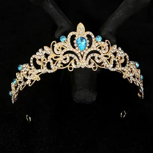 Golden bridal crown with sea blue crystal teardrop and rhinestones on black background
