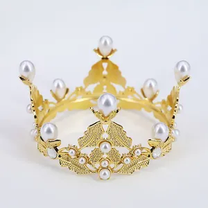 Detailed view of golden baroque crown with intricate metal floral patterns and white pearls