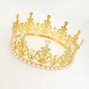 Detailed close-up of golden metal cake crown with white pearls and sparkling rhinestones