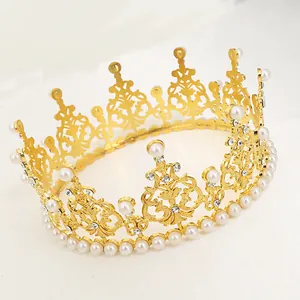 Detailed view of golden baroque crown with hollow carvings, pearls, and crystals
