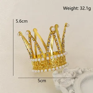 Gold crystal crown cake topper for birthday parties featuring white pearls and rhinestones