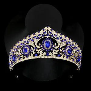 Close-up of gold baroque crown with blue sapphires and sparkling rhinestones