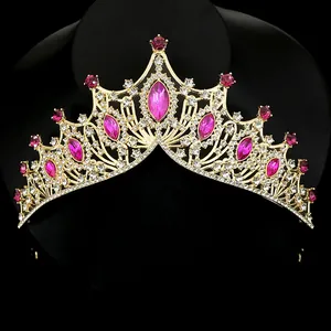 Luxurious gold crown tiara with pink teardrop crystals and white rhinestones