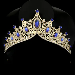Detail of luxury gold crown with deep blue marquise stones and sparkling crystals