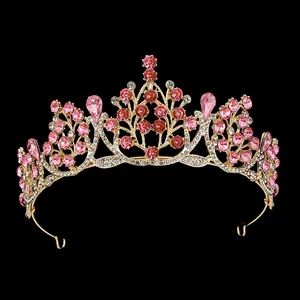 Macro shot of gold wedding crown detailing pink rhinestones and floral alloy patterns