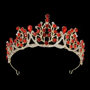 Macro detail of golden baroque crown with red crystals and white rhinestones