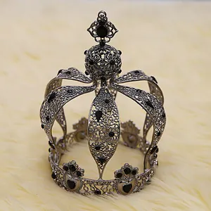 Close-up of vintage silver alloy crown with black rhinestones on soft faux fur