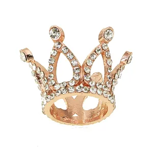 Close-up of rose gold crown ring with sparkling rhinestones for cake decoration and gifts