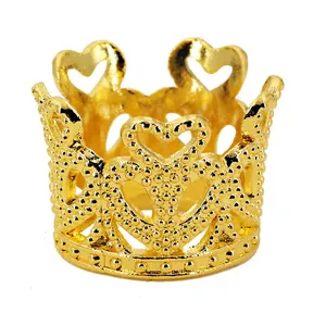 Golden mini crown cake topper with hollow heart design and fine dotted texture detail