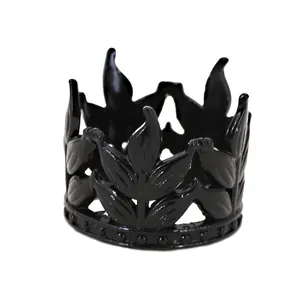 Detailed macro view of black leaf-shaped alloy crown with bead texture for cake decoration