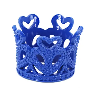 Detail showing royal blue heart-shaped crown cake topper with beaded base relief