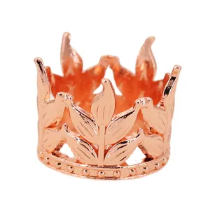 Macro detail of rose gold crown decoration featuring intricate leaf texture and beaded trim
