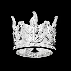 Detailed close-up of silver leaf crown cake topper with intricate beaded metal base