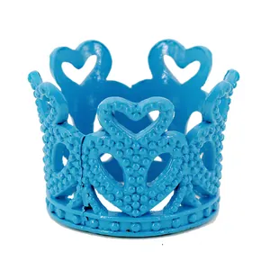 Detail showing blue mini crown with heart pattern and textured metallic beads