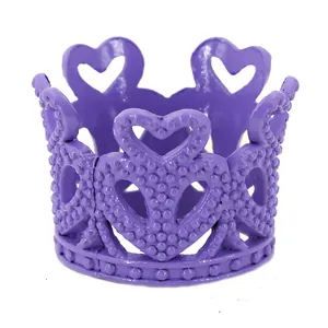 Detailed view of mini purple alloy crown with hollow heart patterns and beaded texture
