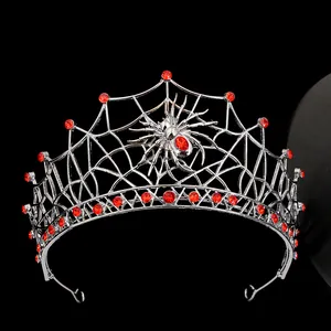 Detailed view of silver spider web crown featuring red rhinestones and spider motif