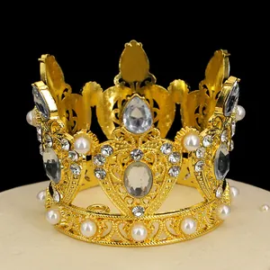Detailed view of a golden alloy crown with teardrop rhinestones and elegant white pearls
