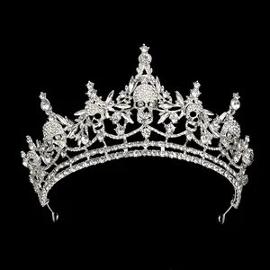 Macro detail of gothic silver crown featuring rhinestone-encrusted skulls and metal band